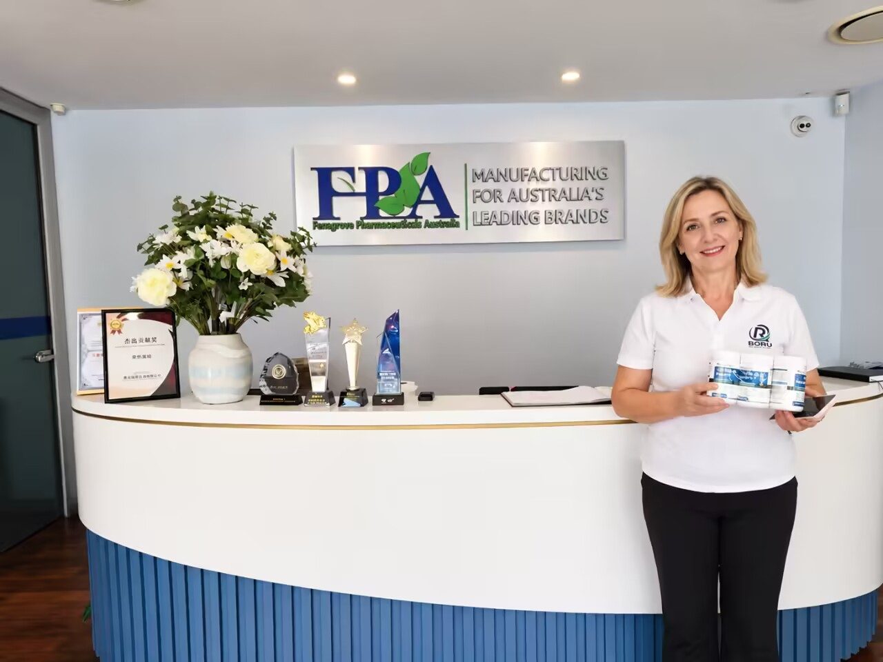 Borui team member holding product at Ferngrove Pharmaceuticals Australia reception